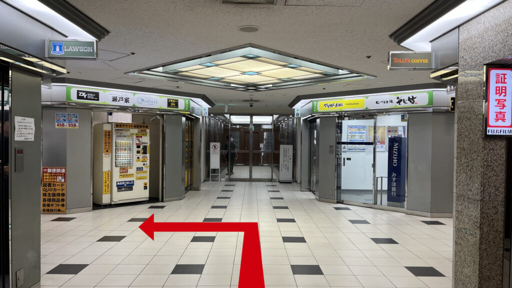 ZXY本町への行き方:御堂筋本町ビルB1Fのエントランスから中に入った図 右にタリーズコーヒー、正面右にみずほ銀行、正面左にチケット券売機、左にローソンが見える十字路